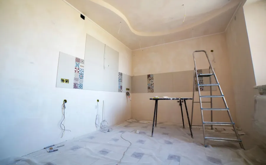 Cara memilih kontraktor renovasi rumah profesional sedang berdiskusi denah bangunan di lokasi proyek