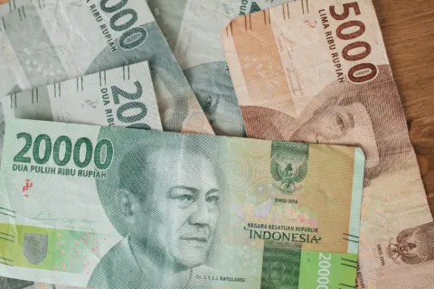Ilustrasi perencanaan keuangan dengan cara mengatur budget liburan bulanan menggunakan aplikasi bank digital